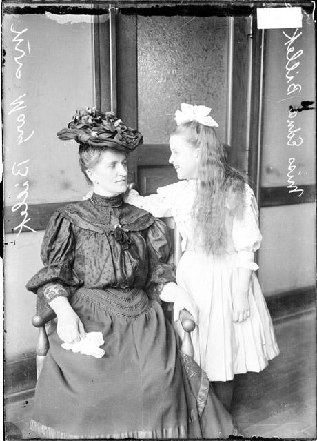 Chicago Daily News Photograph, circa 1907, accessed Chicago History Museum. Collection caption: [Mrs. Mary Billick, sitting, and Edna Billick, standing, looking at each other.